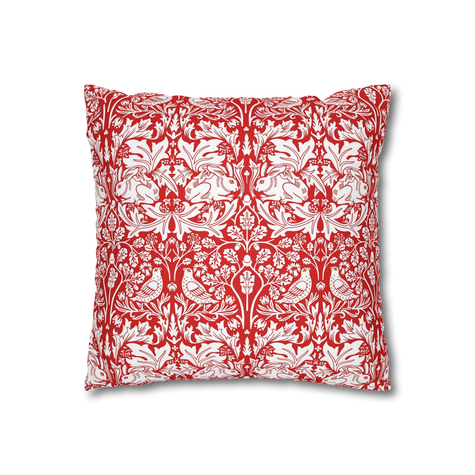 Decorative pillow with red and white floral and bird pattern on a white background