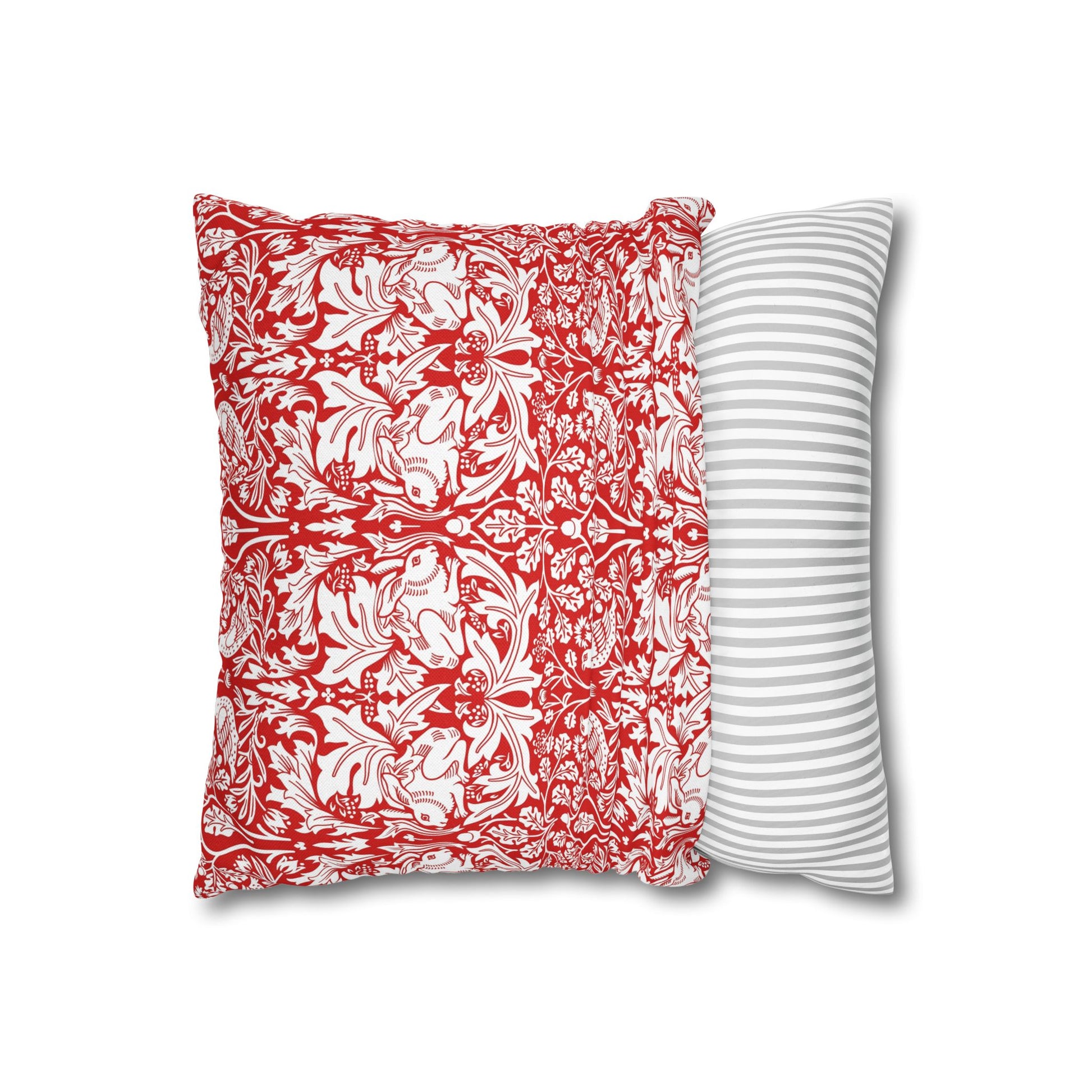 Two pillows, one with red floral pattern and one with white stripes, on a white background.