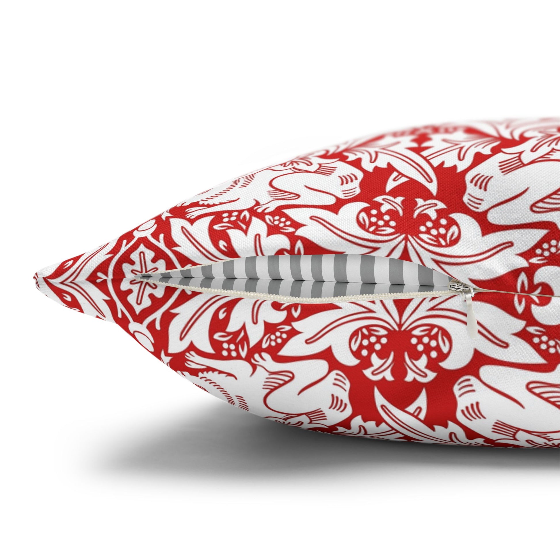 Decorative pillow with red and white pattern on a white background