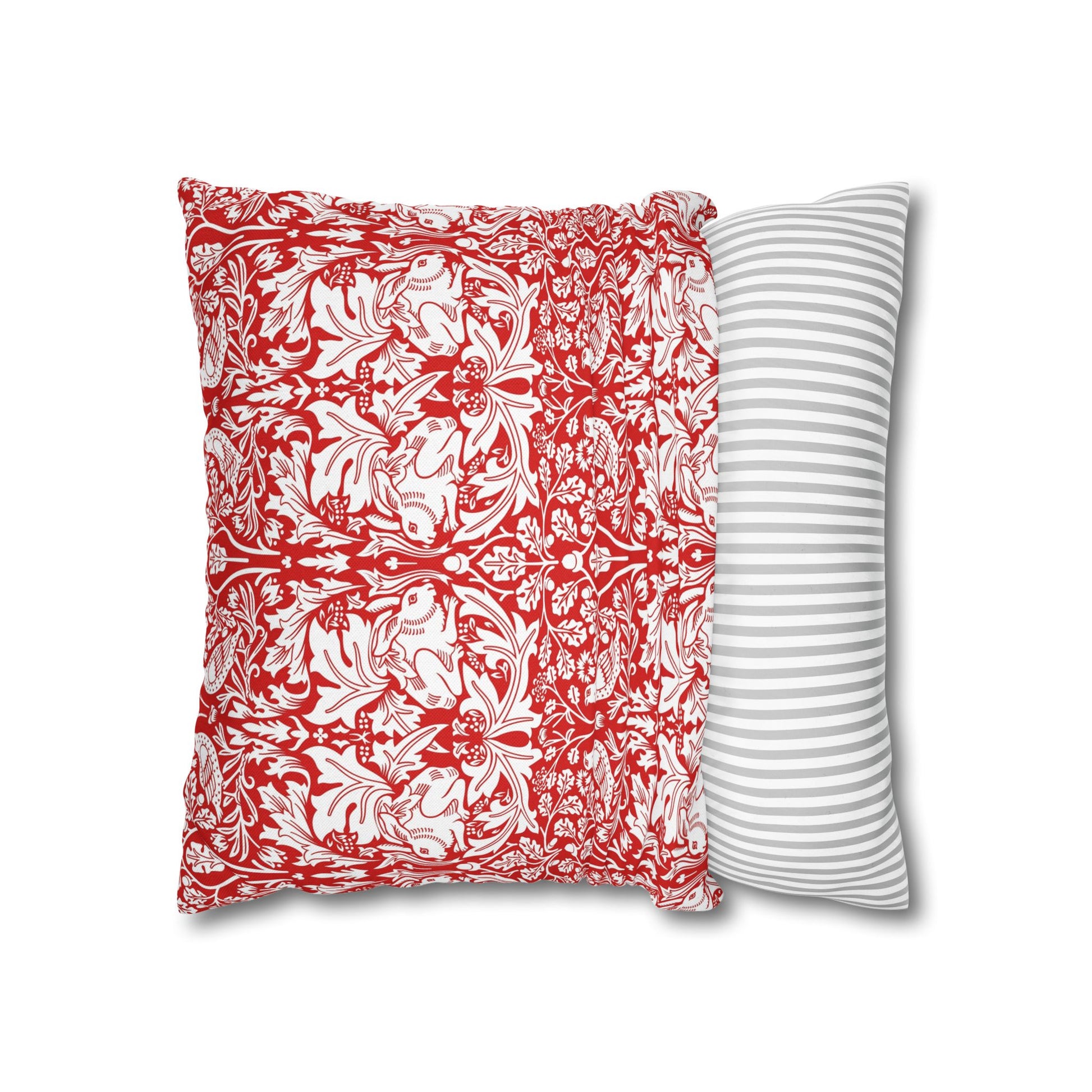 Two pillows, one with a red and white floral pattern and the other with a gray and white striped pattern, on a white background.