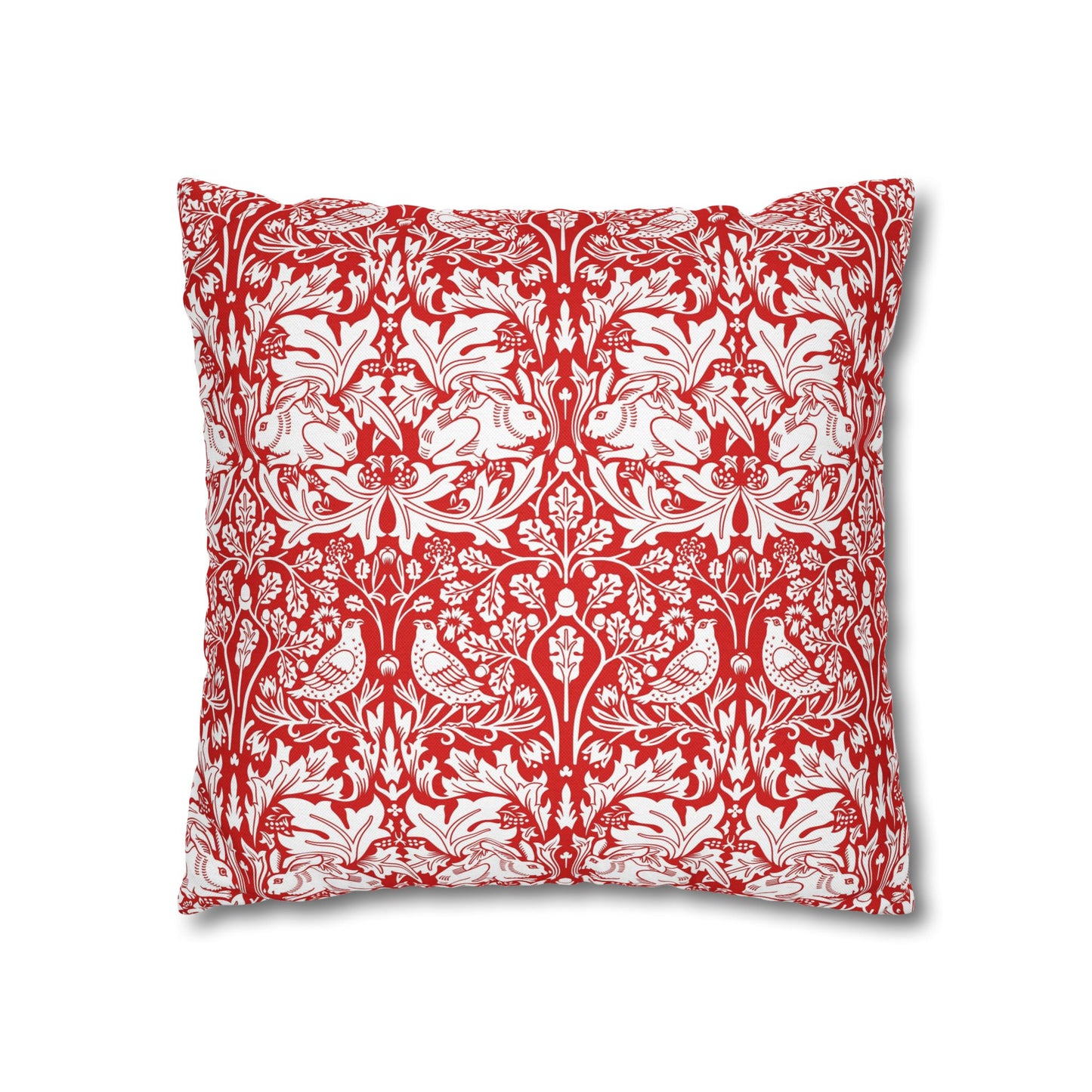 Decorative pillow with red and white floral and bird pattern on a white background