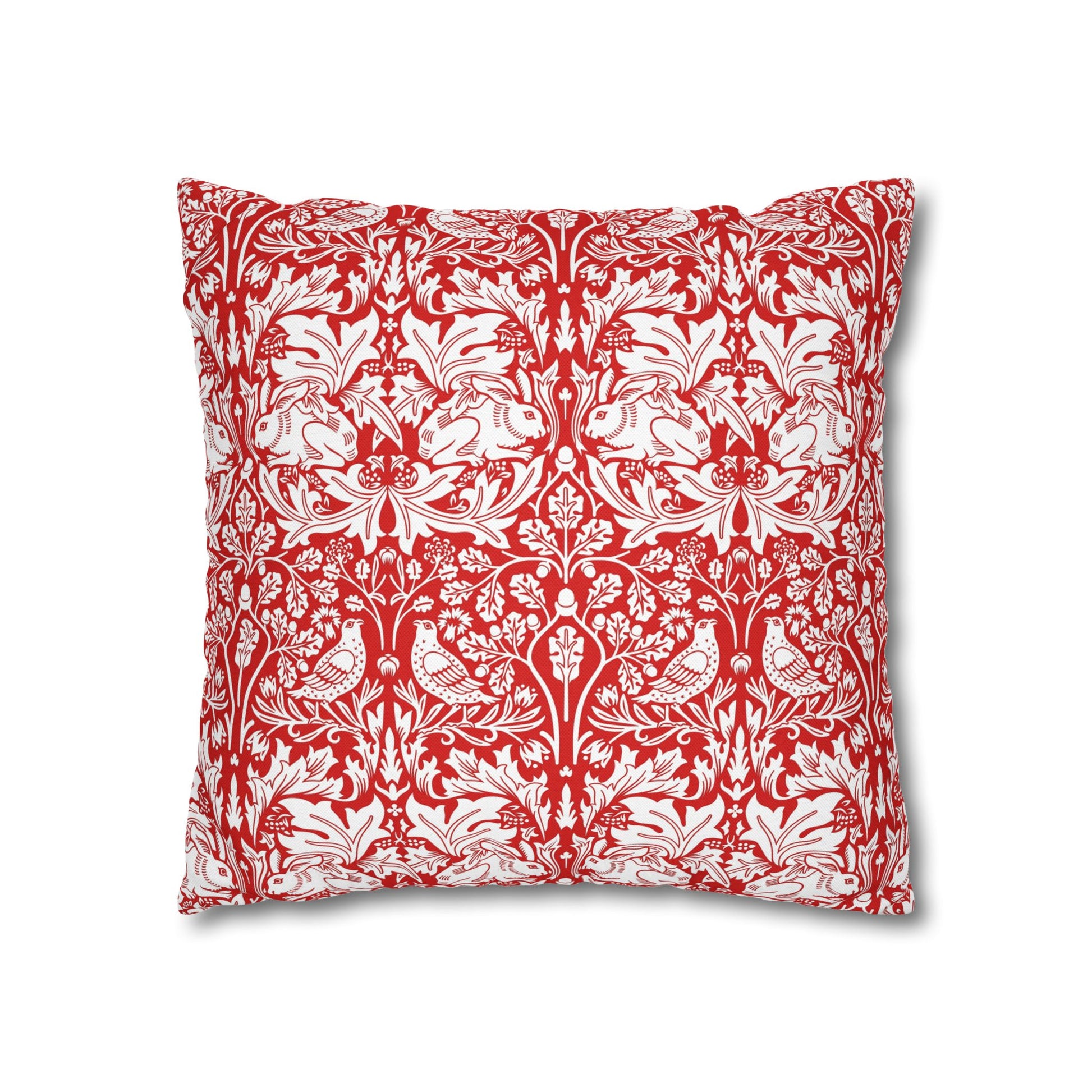 Decorative pillow with red and white floral and bird pattern on a white background