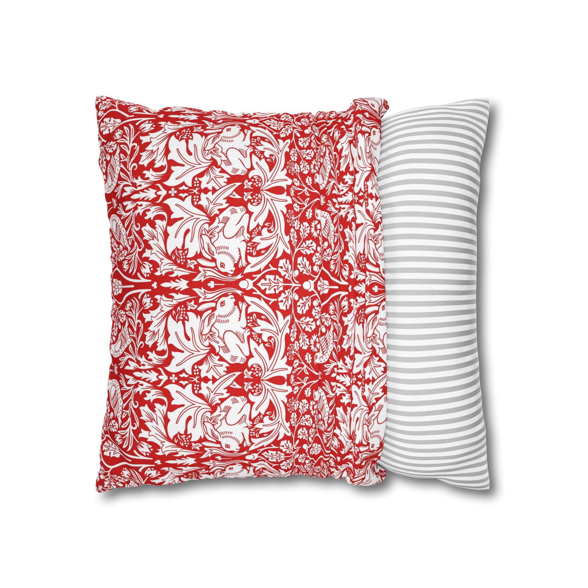 Two pillows, one with red and white floral pattern and the other with gray and white stripes, on a white background.