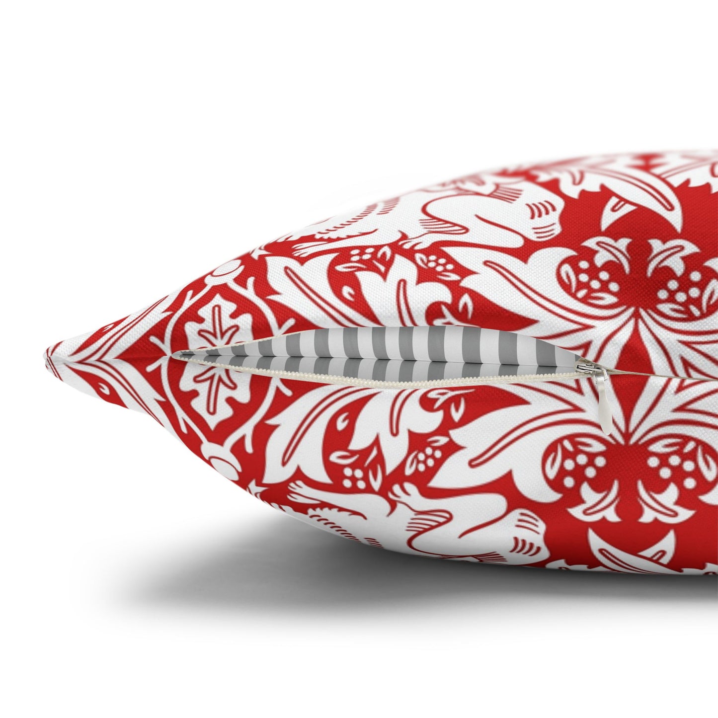 Decorative pillow with red and white pattern on a white background