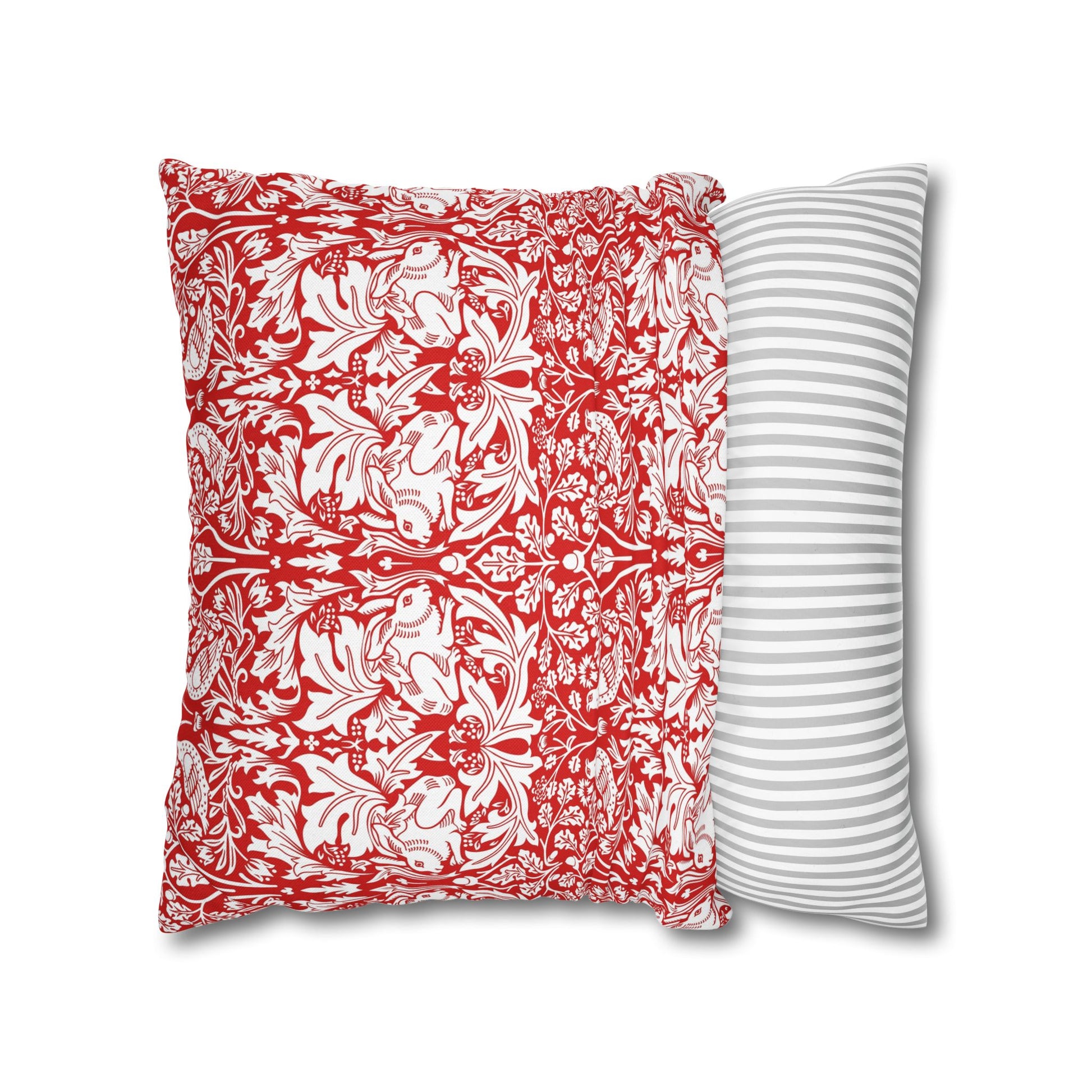 Two pillows, one with red and white floral pattern and the other with gray and white stripes, on a white background.