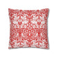 Decorative pillow with red and white floral and bird pattern on a white background