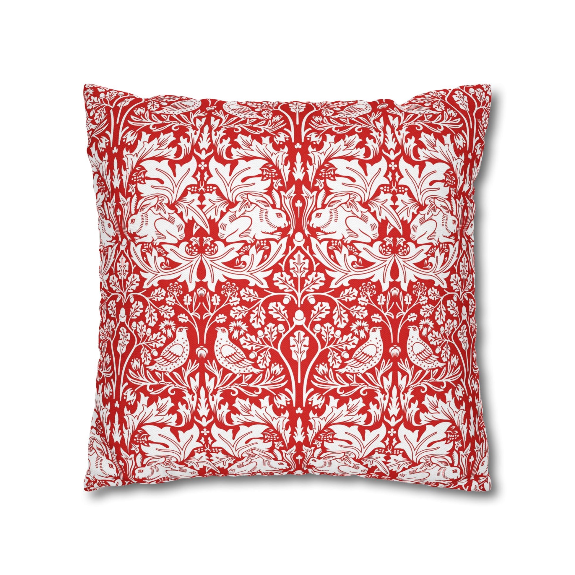 Decorative pillow with red and white floral and bird pattern on a white background