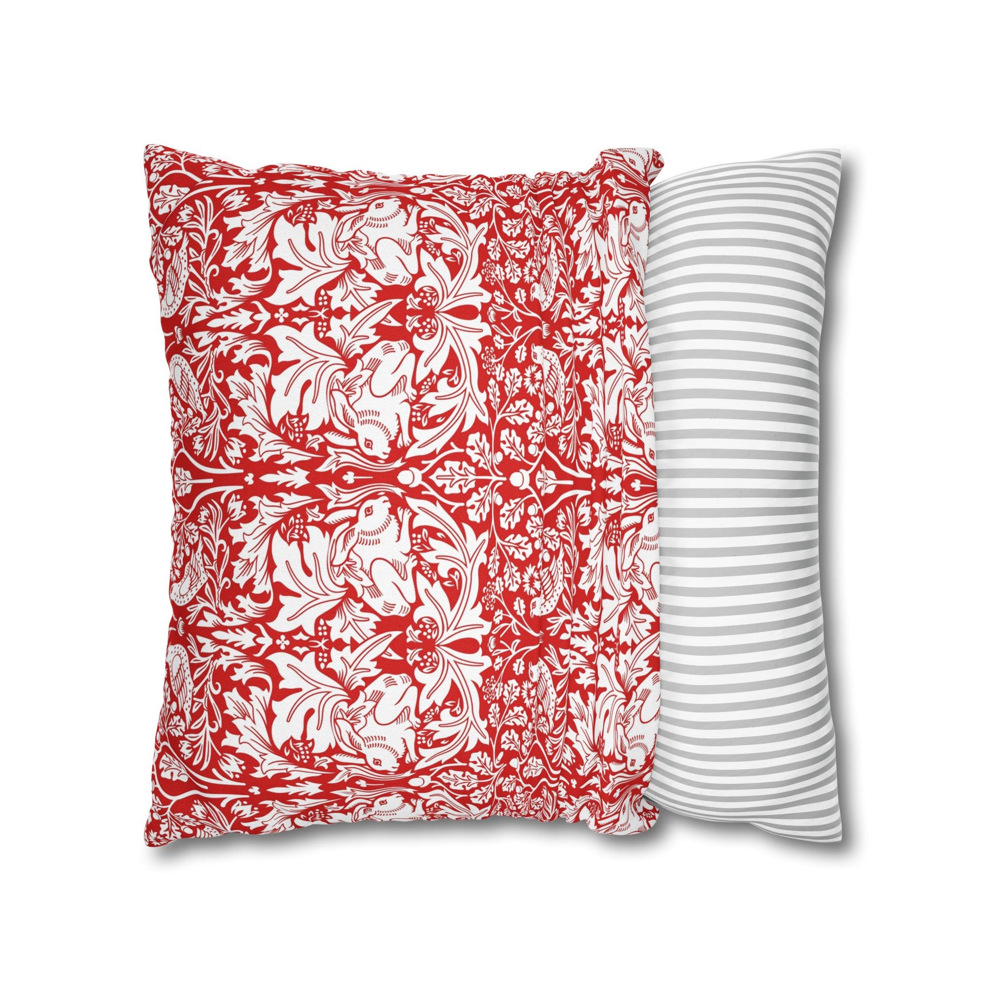 Two pillows, one with red and white floral pattern and the other with gray and white stripes, on a white background.