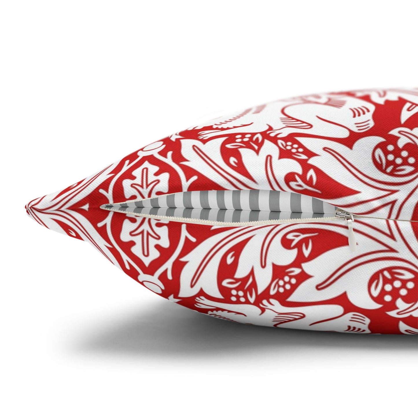 Red and white patterned pillow on a white background