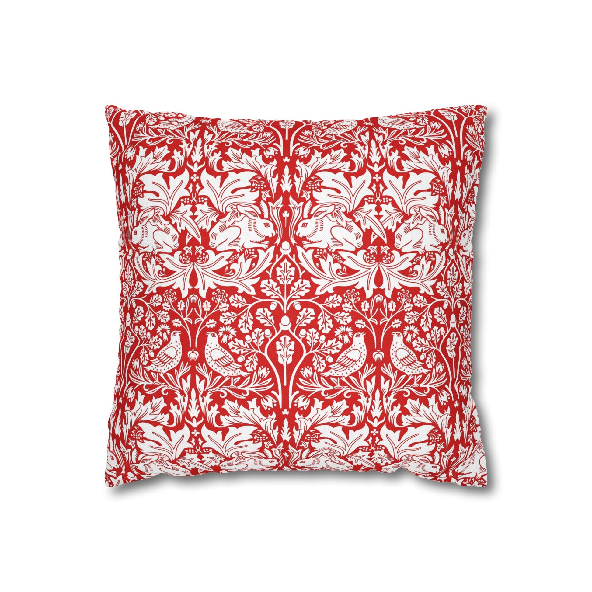 Decorative pillow with red and white floral and animal pattern on a white background