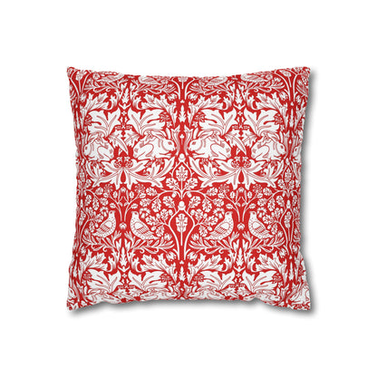 Decorative pillow with red and white floral and animal pattern on a white background