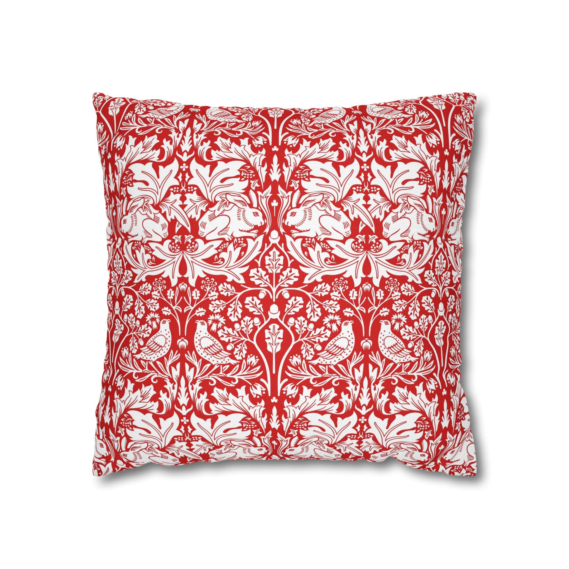 Decorative pillow with red and white floral and bird pattern on a white background