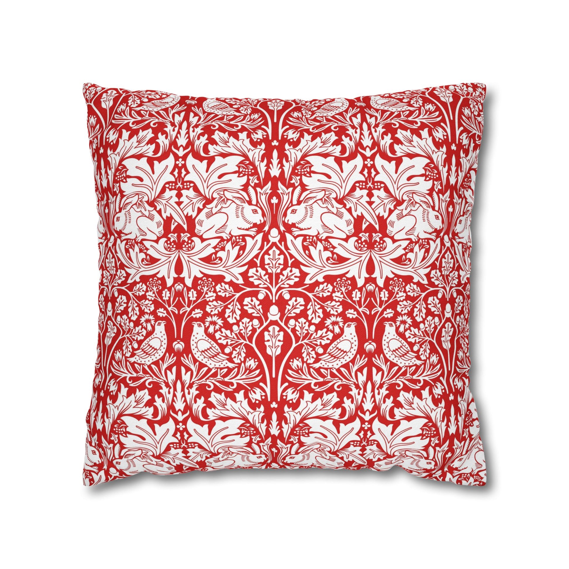 Decorative pillow with red and white floral and bird pattern on a white background