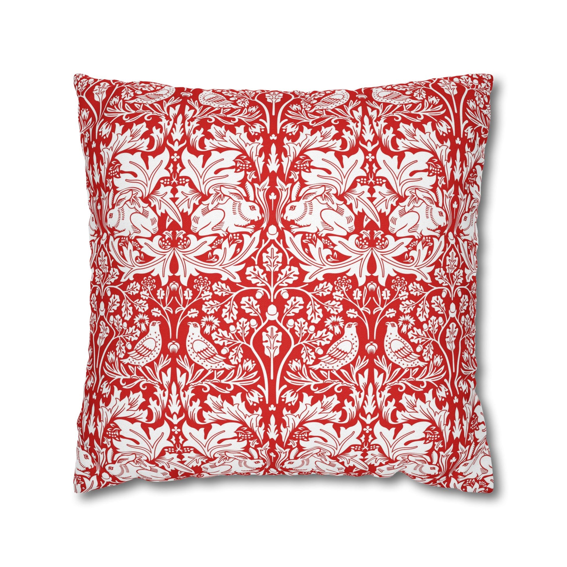 Decorative pillow with red and white floral and animal pattern on a white background