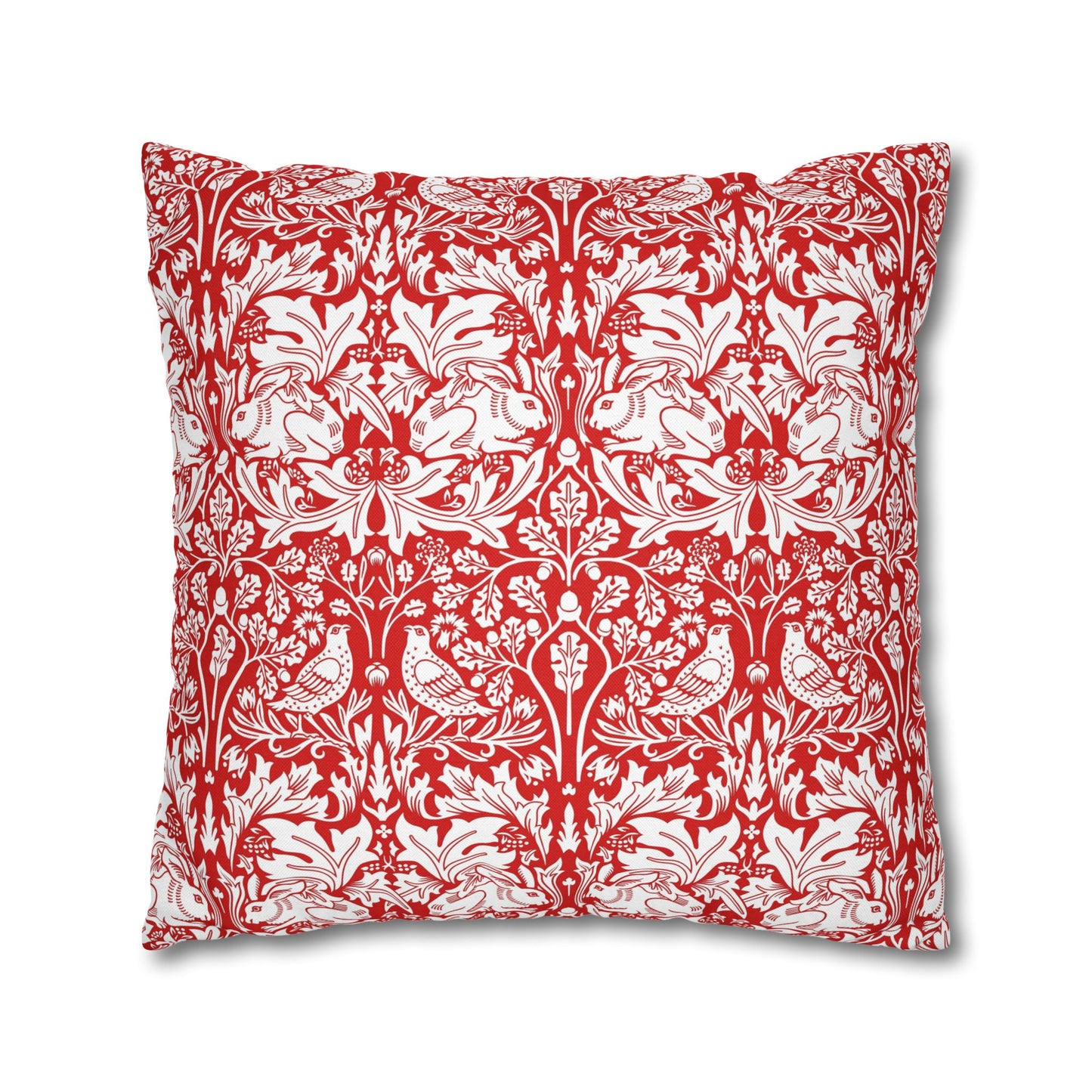 Decorative pillow with red and white floral and bird pattern on a white background