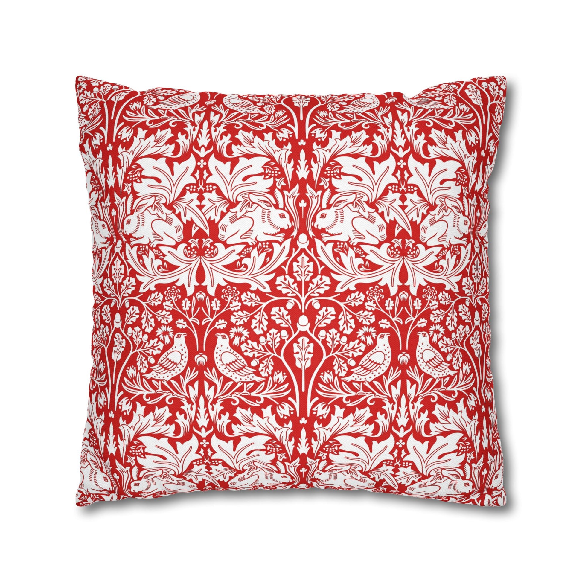 Decorative pillow with red and white floral and bird pattern on a white background