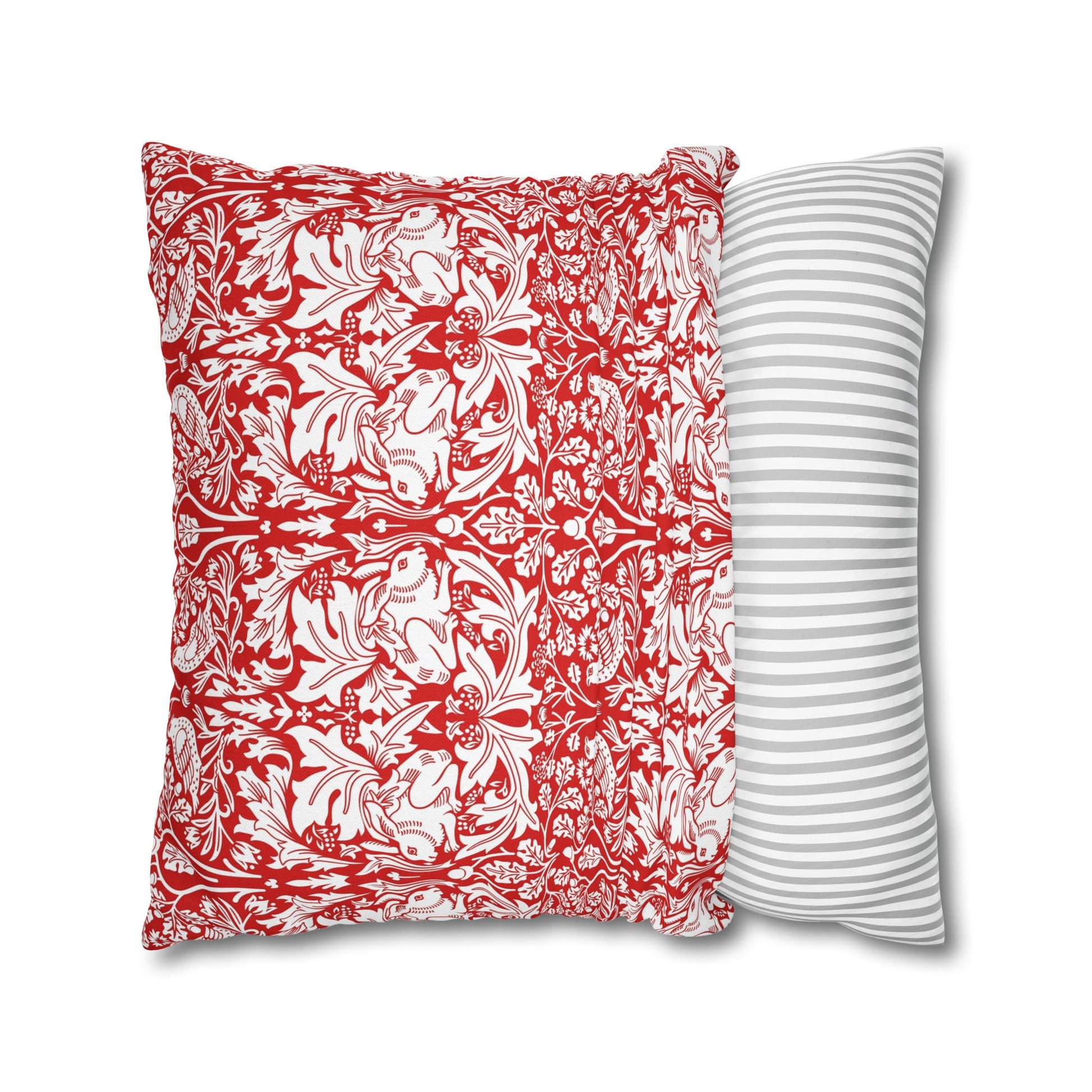 Two pillows, one with red floral pattern and one with white stripes, on a white background.