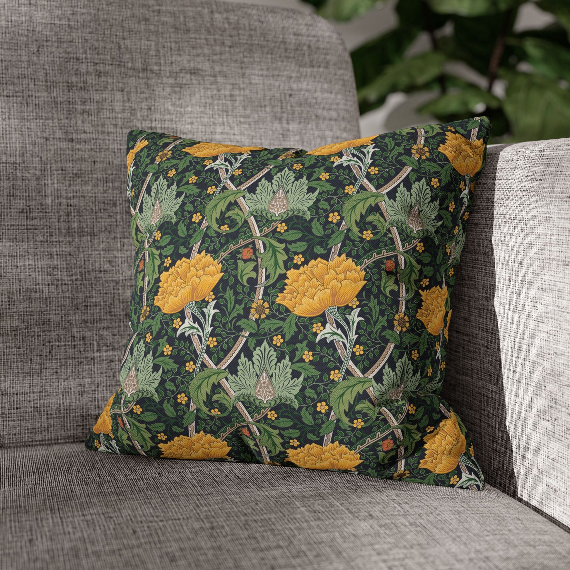 Decorative pillow with floral pattern on a gray sofa