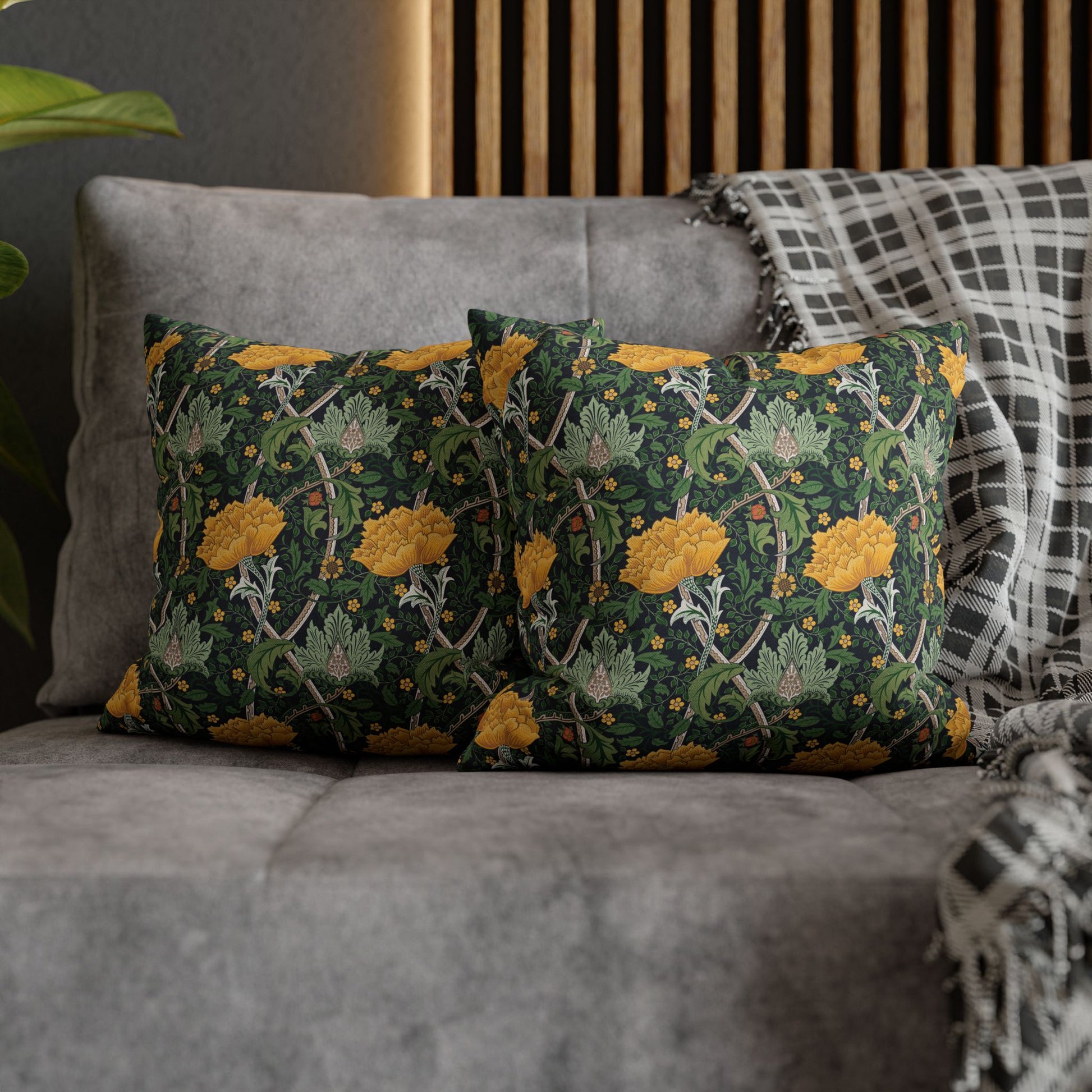 Decorative pillows with floral pattern on a gray sofa