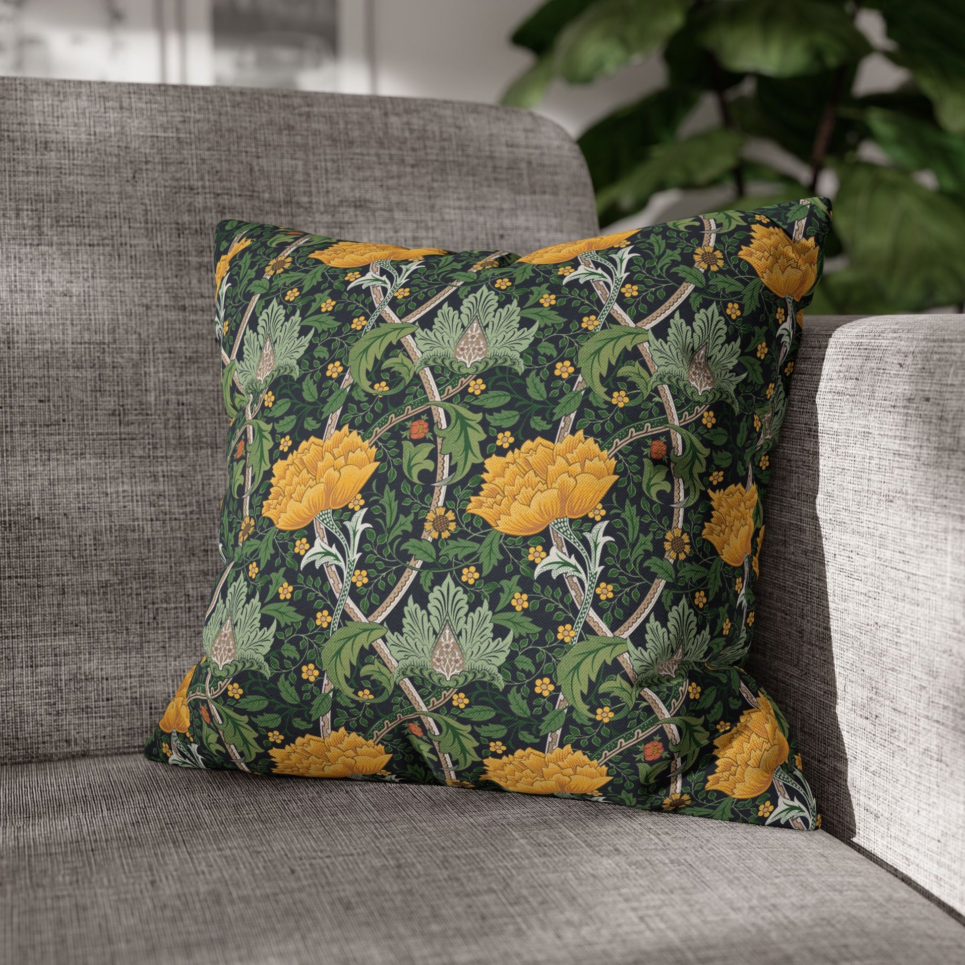 Decorative pillow with floral pattern on a gray sofa