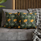 Decorative pillows with floral pattern on a gray sofa against a wooden headboard.
