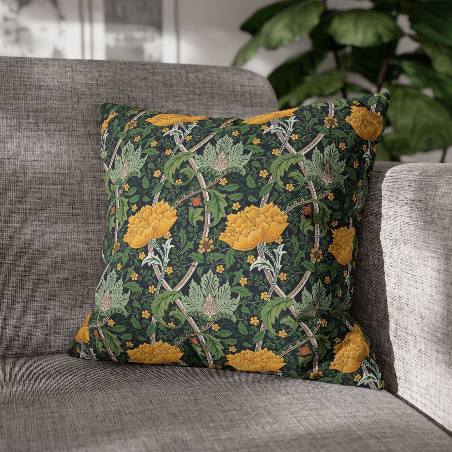 Decorative pillow with floral pattern on a gray sofa