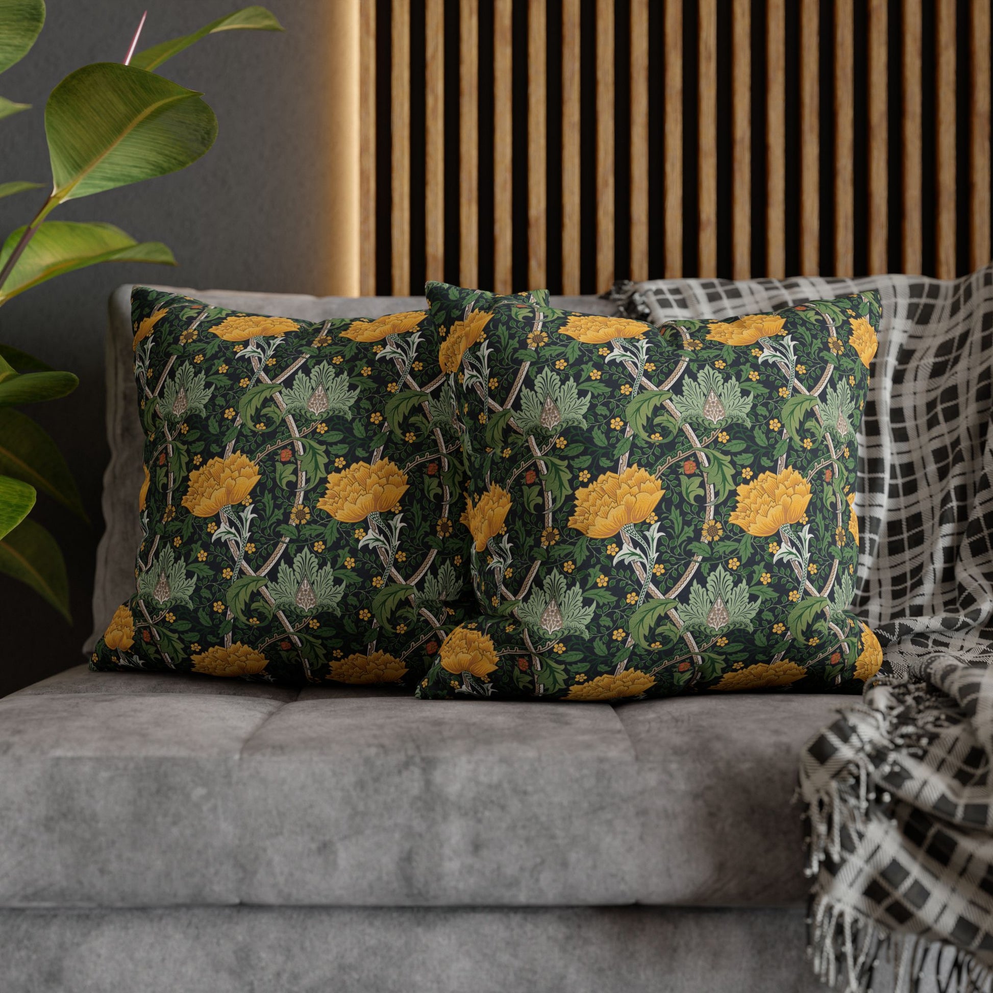 Decorative pillows with floral pattern on a gray sofa