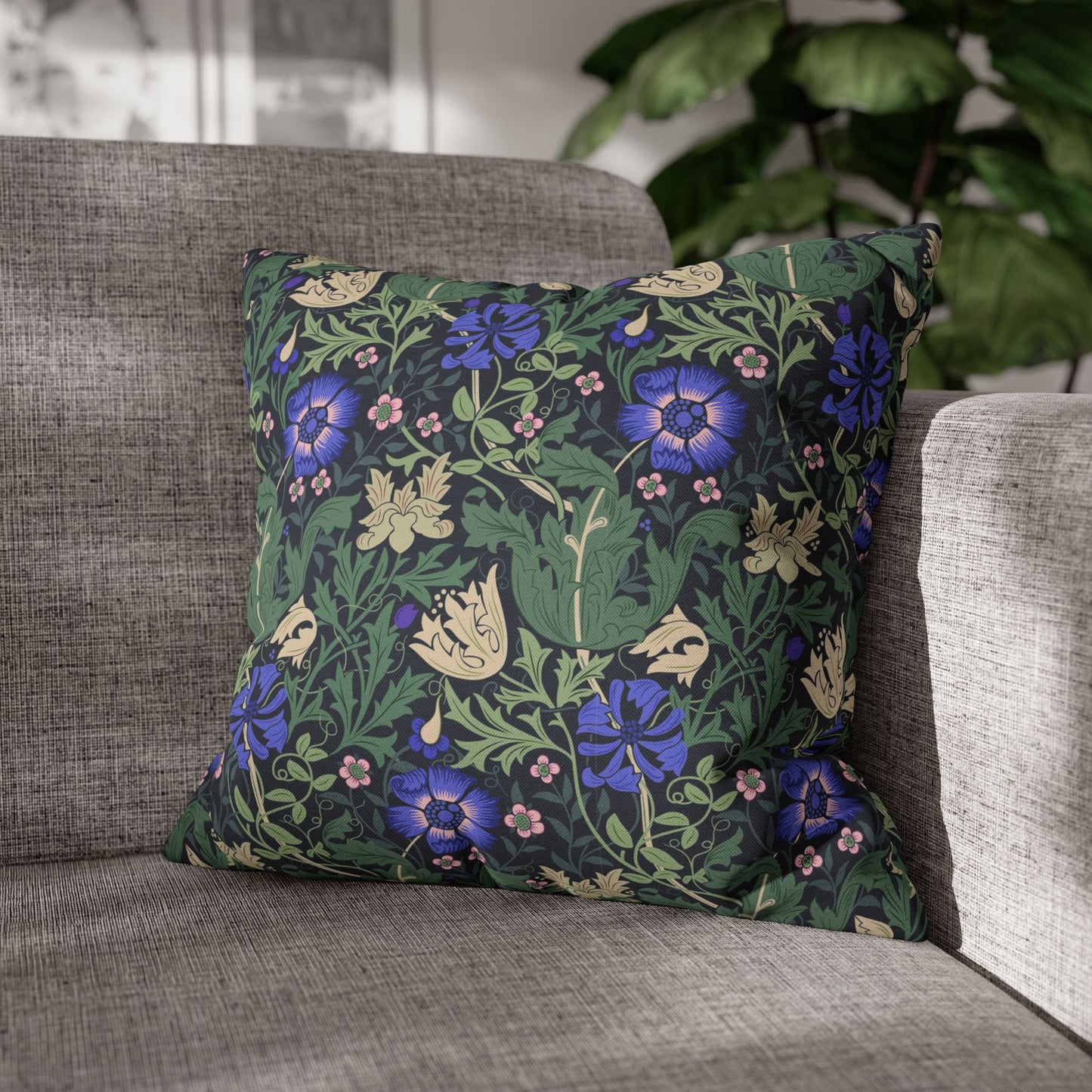 Decorative pillow with floral pattern on a gray sofa