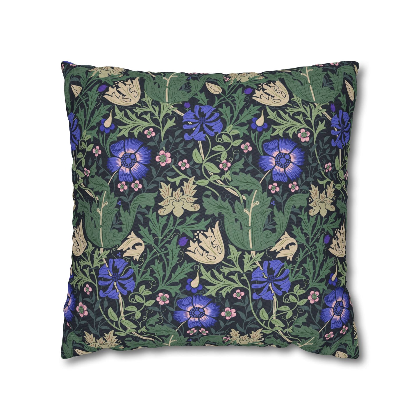 Floral patterned pillow with blue flowers and green leaves on a white background