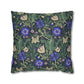 Floral patterned pillow with blue flowers and green leaves on a white background