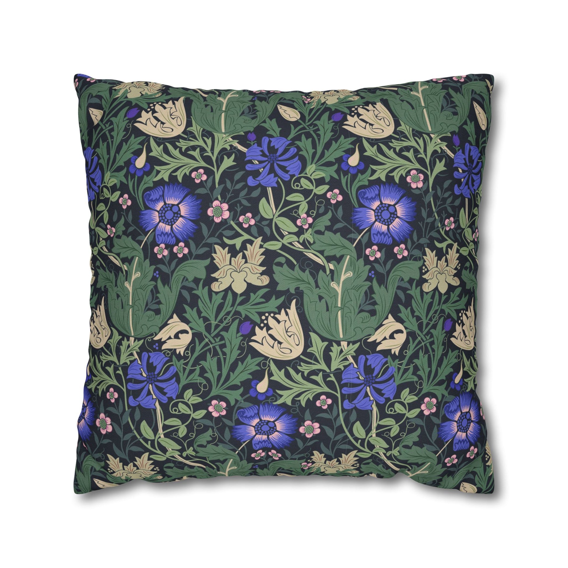 Floral patterned pillow with blue flowers and green leaves on a white background