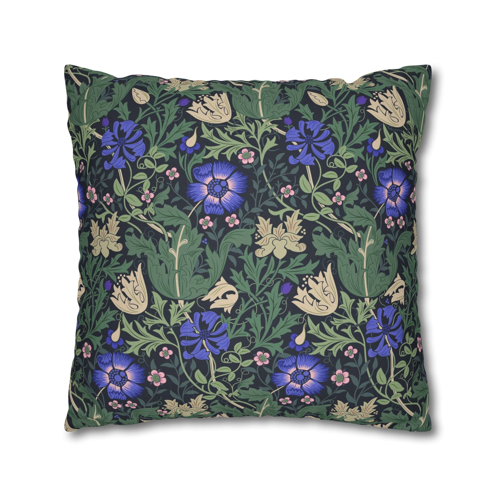 Floral patterned pillow with blue flowers on a green background