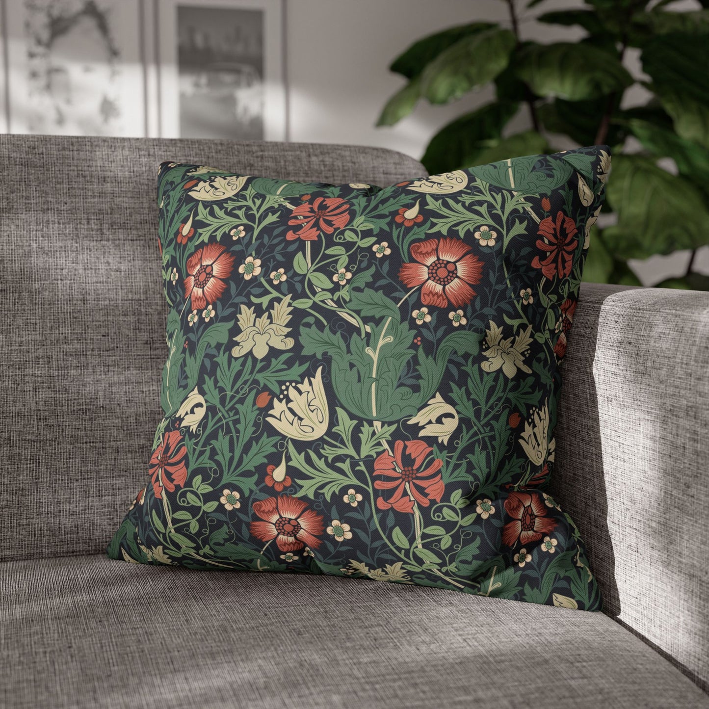 Floral patterned pillow on a gray sofa with a blurred indoor background