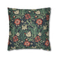 Floral patterned pillow with red flowers and green leaves on a dark background