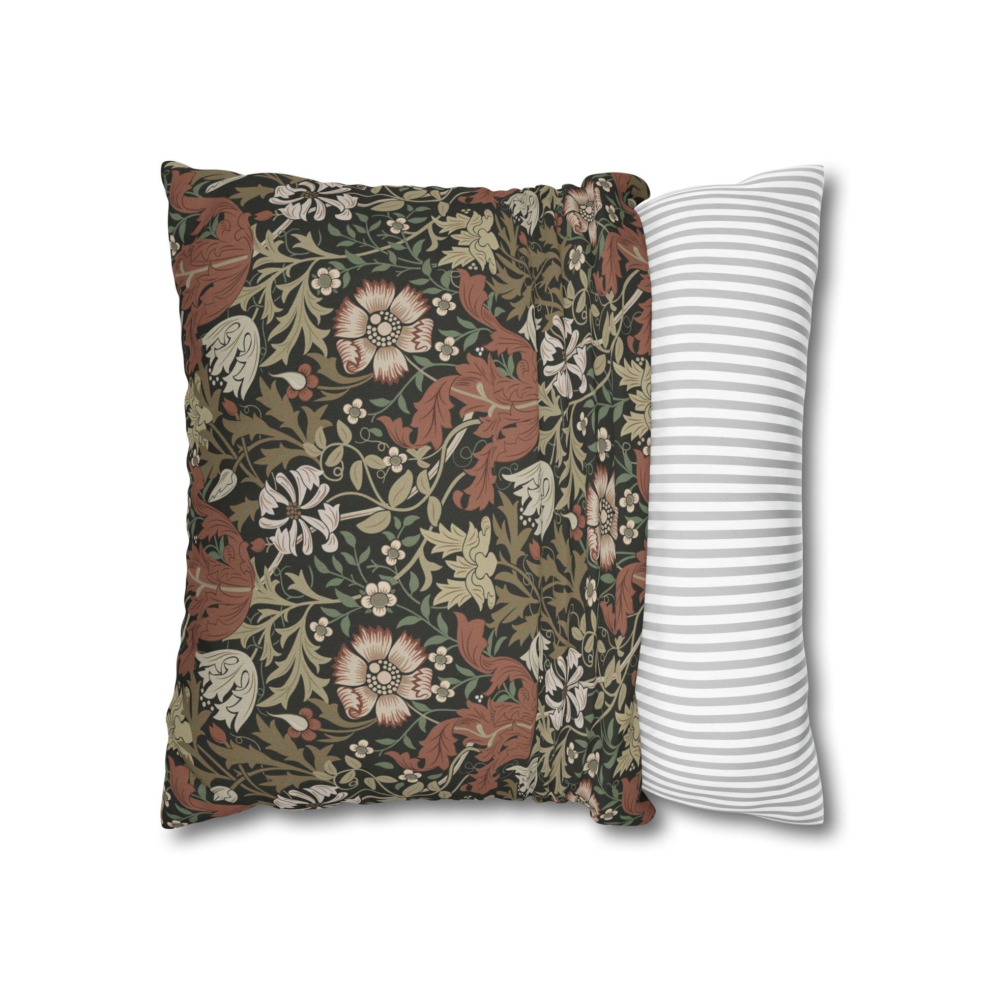 Decorative pillow with floral pattern next to a striped pillow on a white background