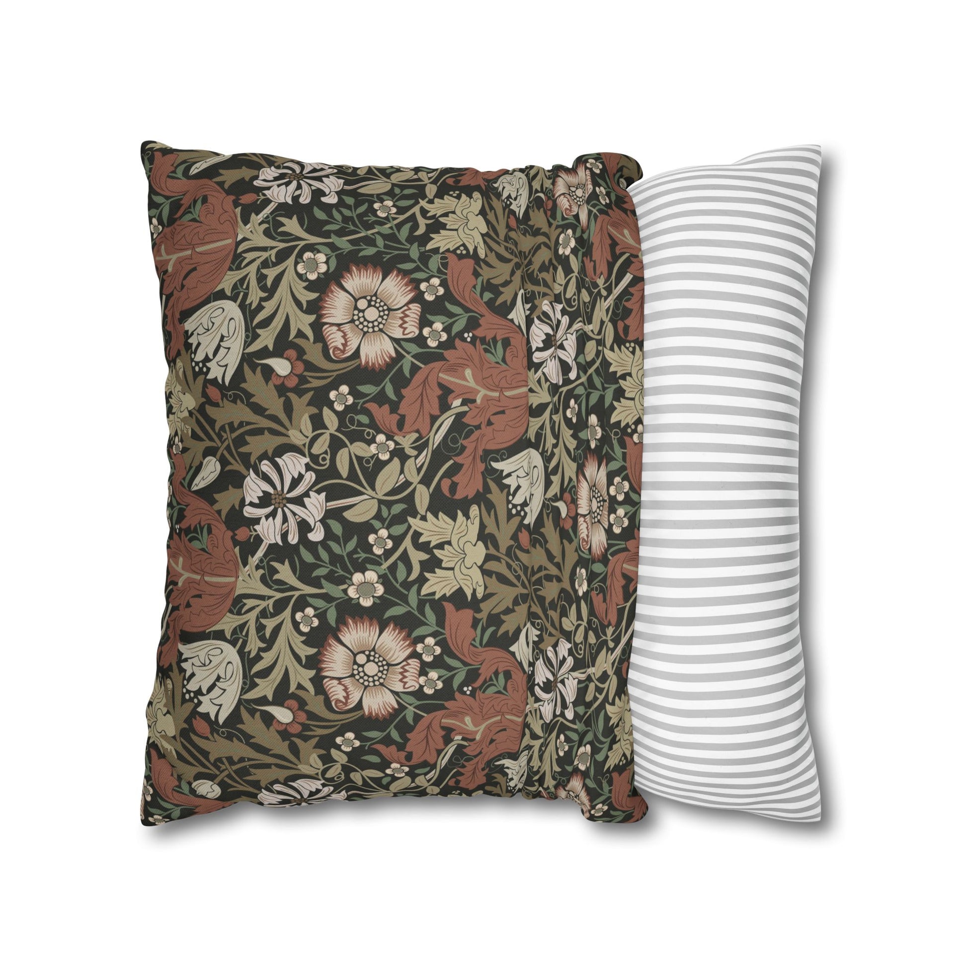 Decorative pillow with floral and animal pattern next to a striped pillow on a white background