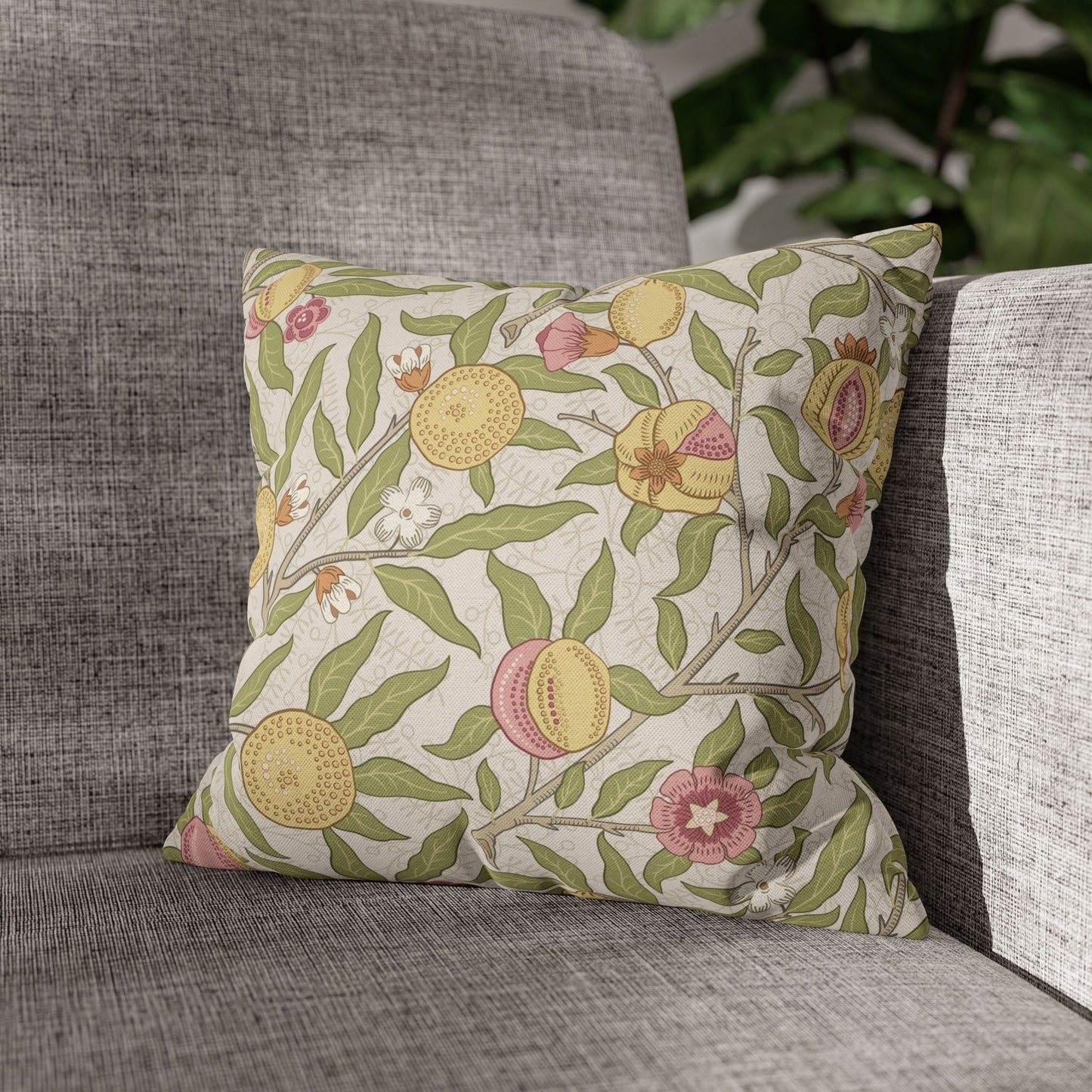Decorative pillow with floral pattern on a gray sofa