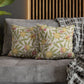 Decorative pillows with floral pattern on a gray sofa