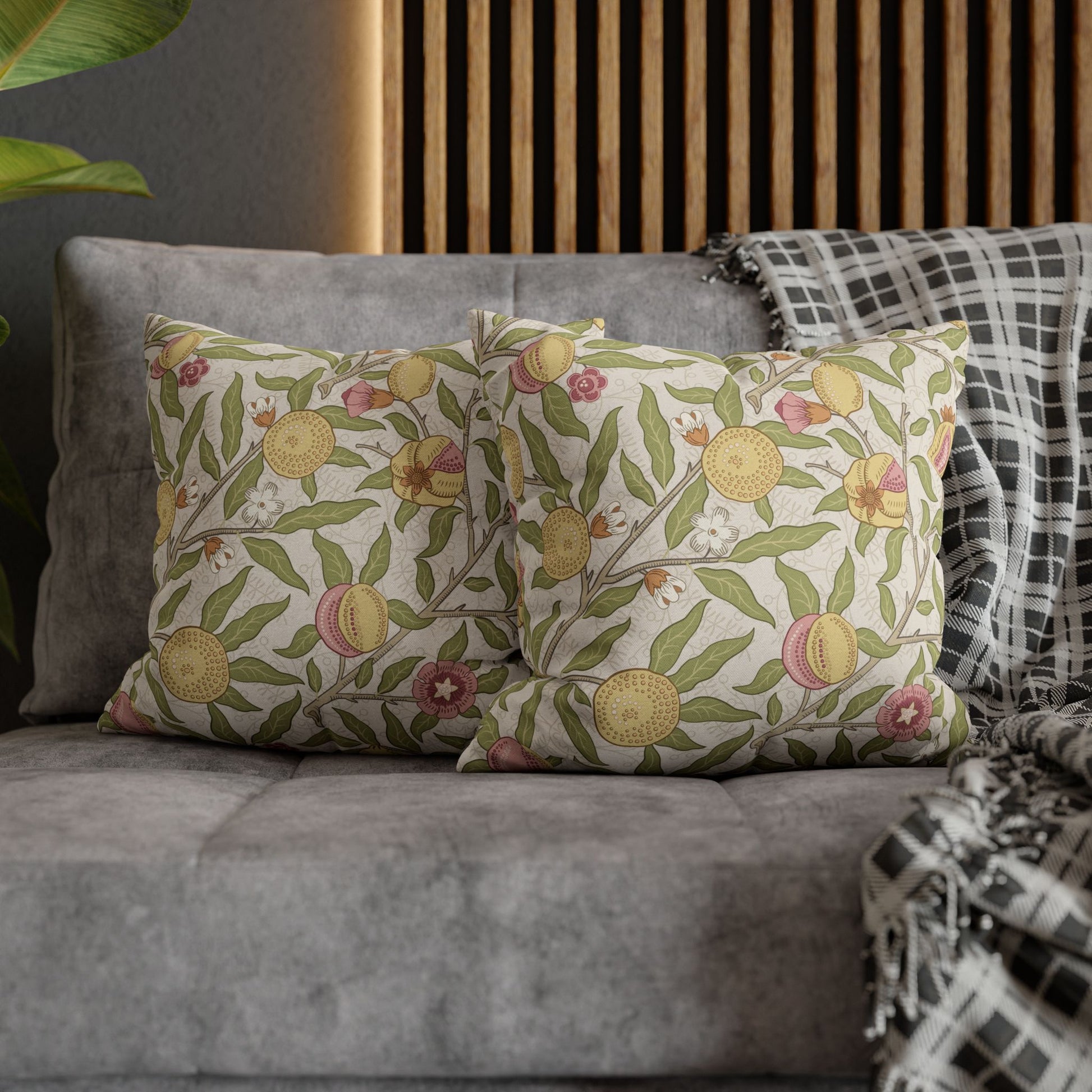 Decorative pillows with floral pattern on a gray sofa