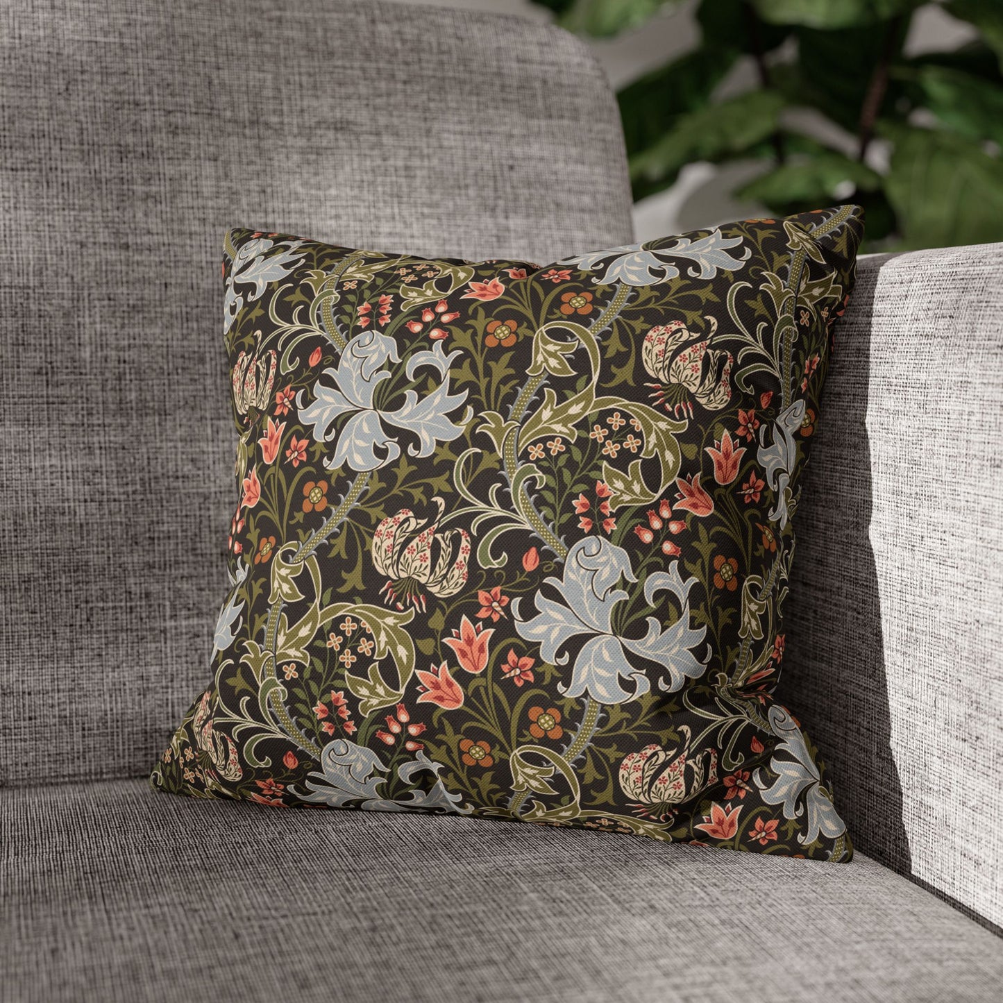 Decorative pillow with floral pattern on a gray sofa