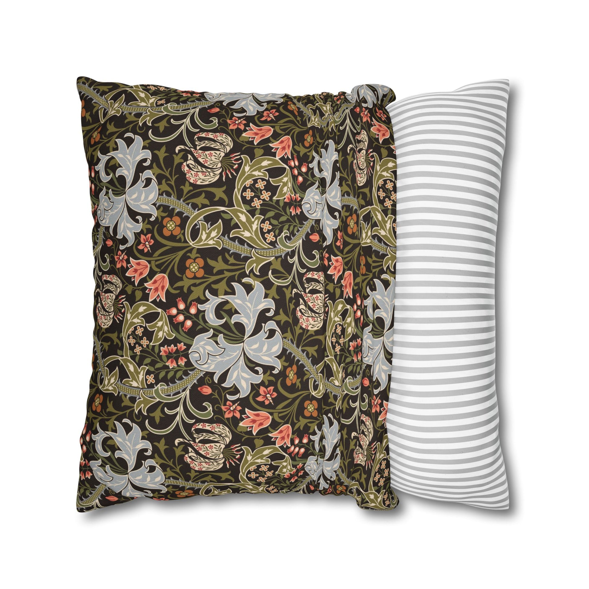 Decorative pillow with floral pattern next to a striped pillow on a white background