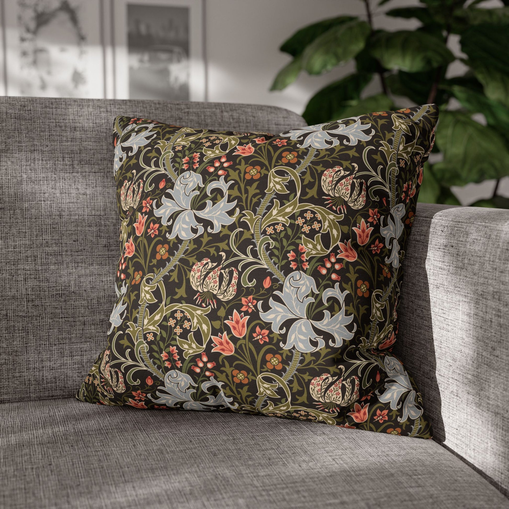 Decorative pillow with floral pattern on a gray sofa