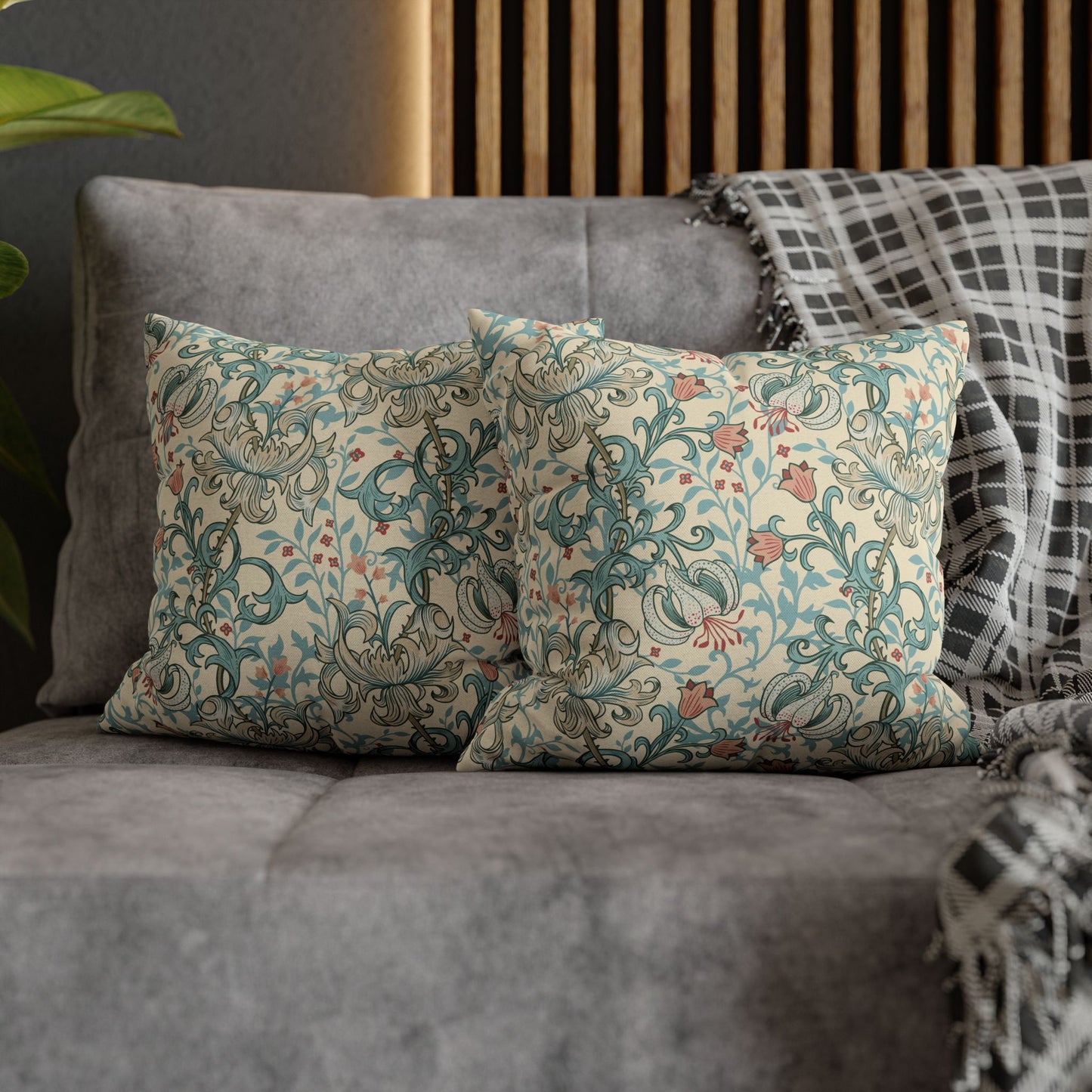 Decorative pillows with floral patterns on a gray sofa.