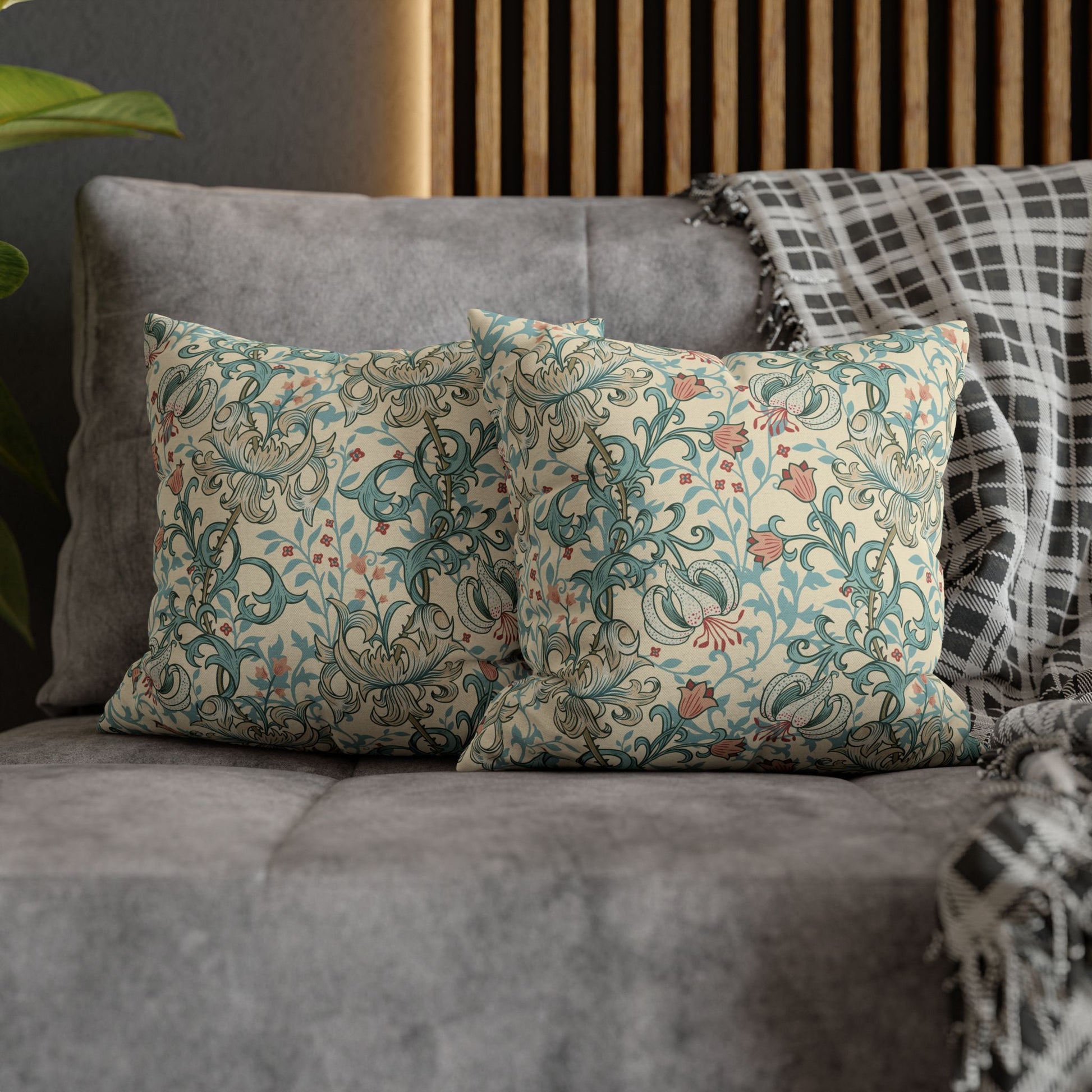 Decorative pillows with floral patterns on a gray sofa.