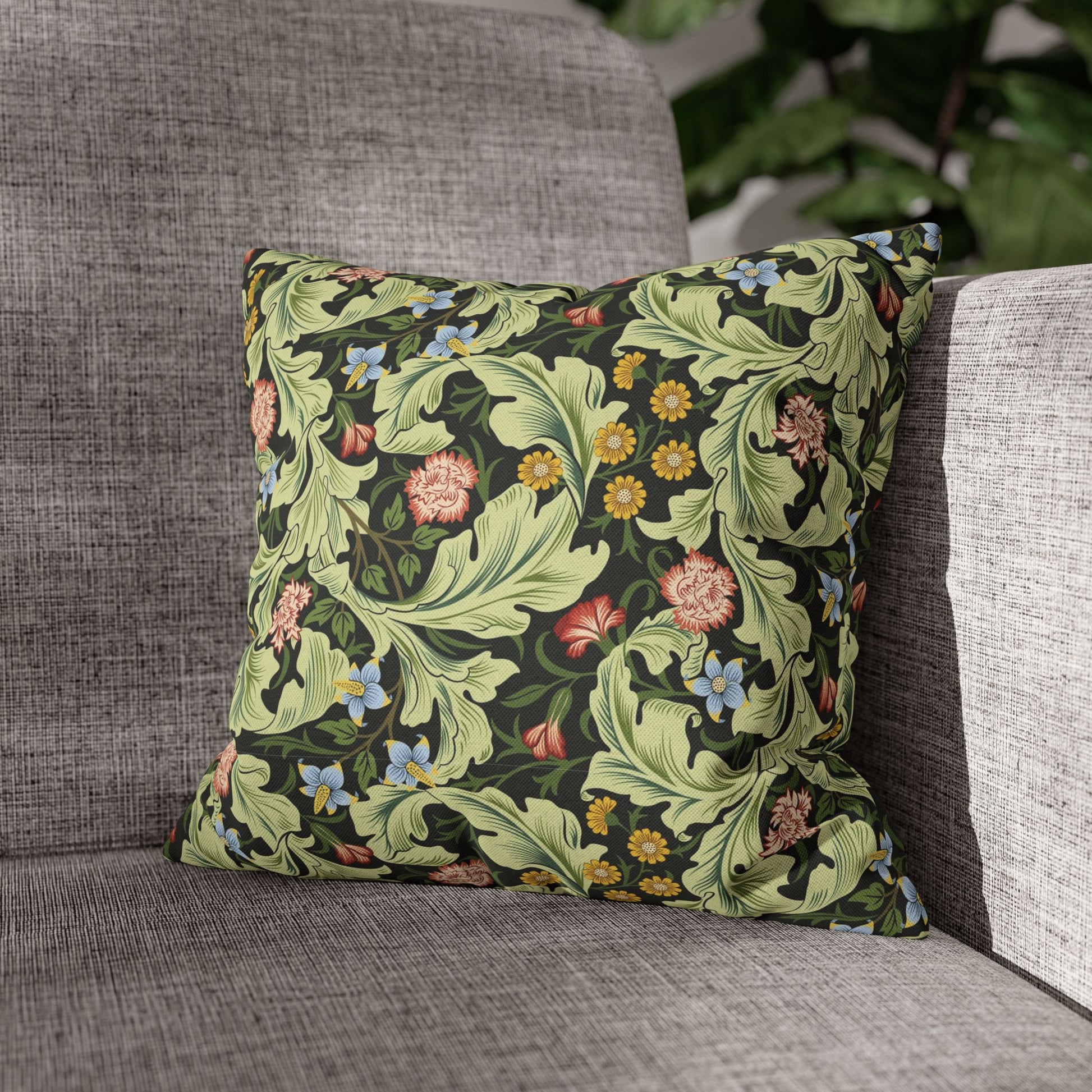 Decorative pillow with floral pattern on a gray sofa - william morris leicester