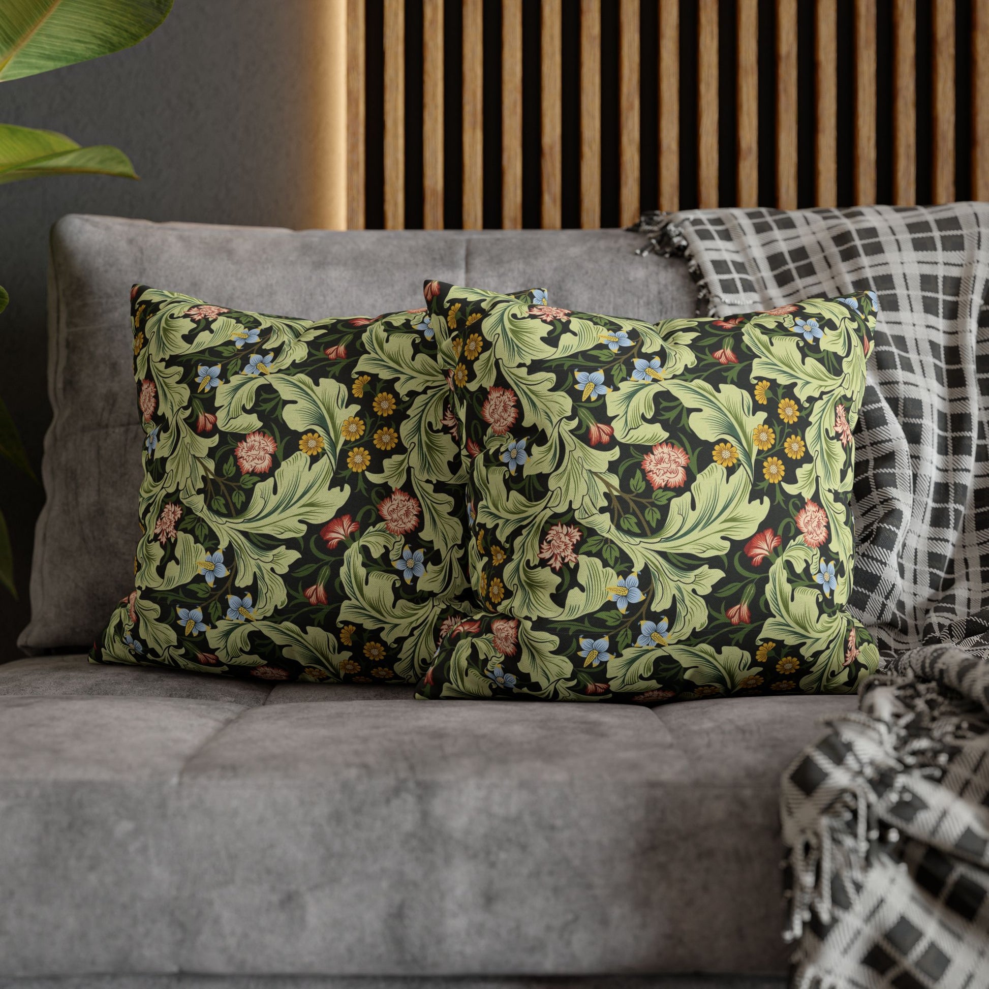 Decorative pillows with floral patterns on a gray sofa - William Morris Leicester