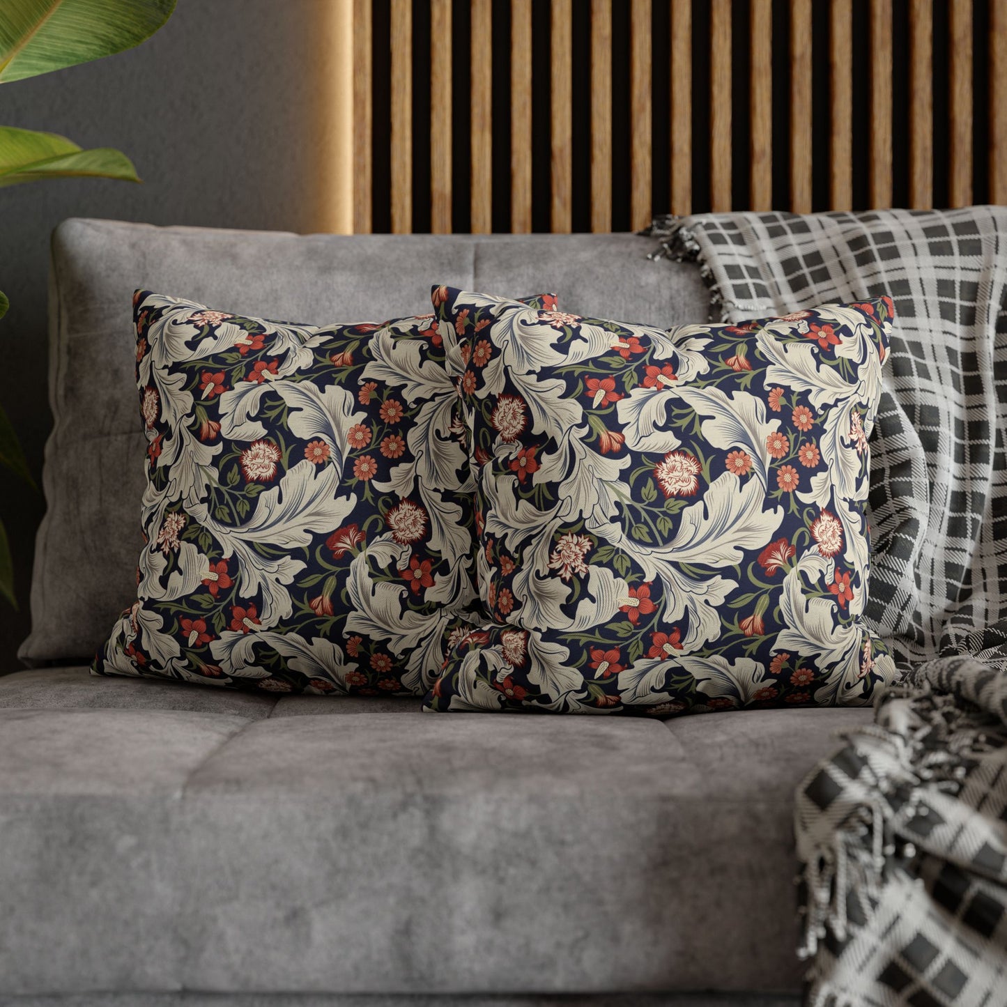 Decorative pillows with floral patterns on a gray sofa.