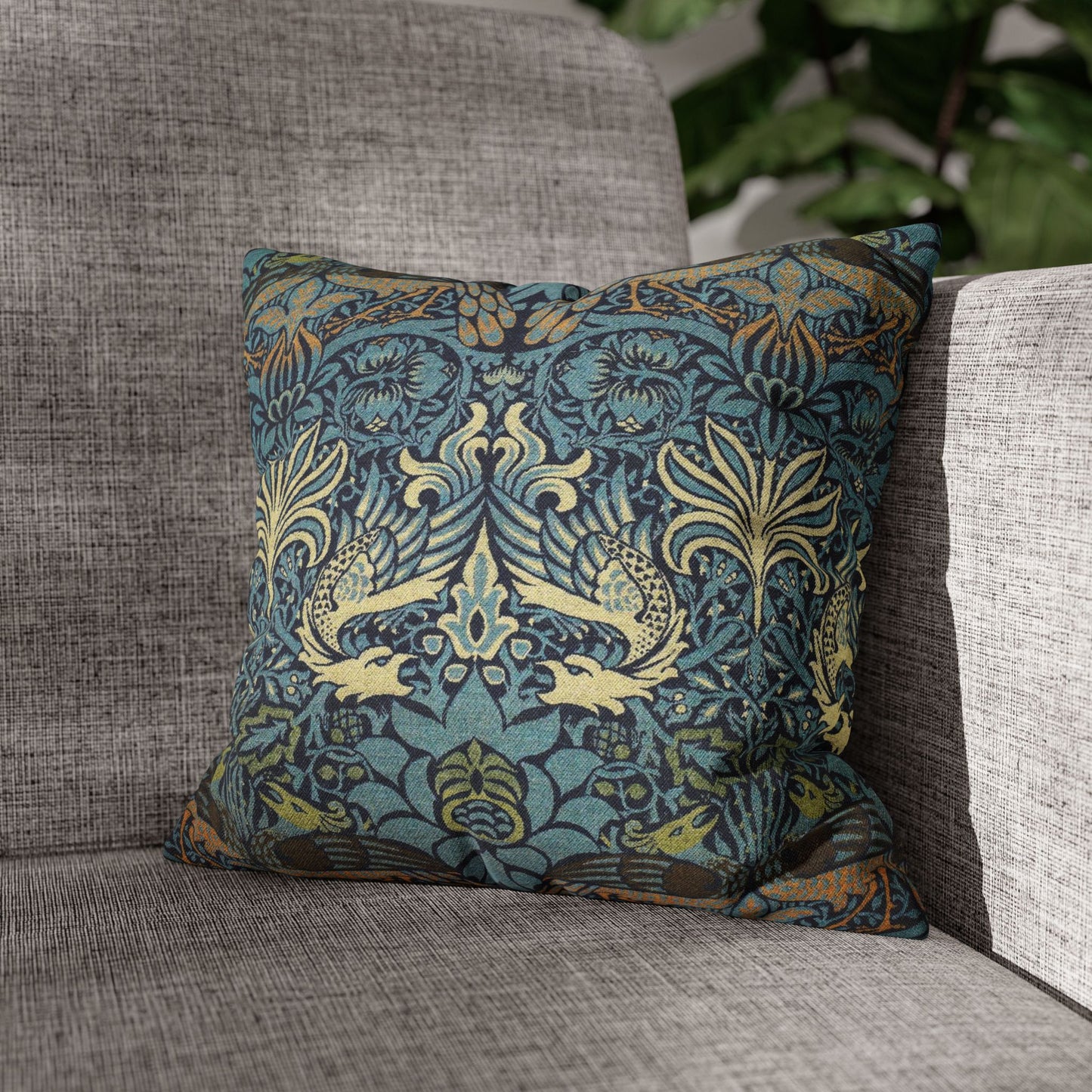 Decorative pillow with intricate pattern on a gray sofa