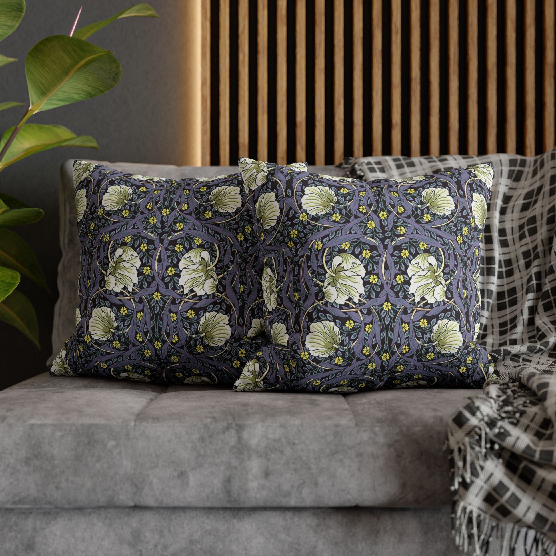 Decorative pillows with floral pattern on a gray sofa
