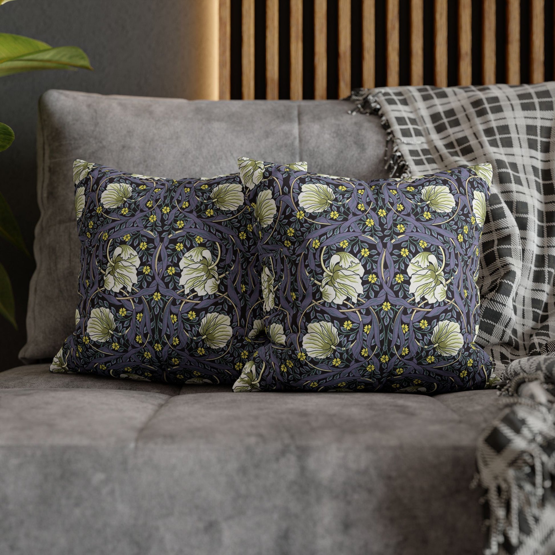 Decorative pillows with floral pattern on a gray sofa